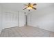 Minimalist bedroom with neutral-toned tile flooring, ceiling fan, and closet at 3717 46Th S Ave # 6, St Petersburg, FL 33711