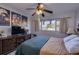 Comfortable bedroom with a ceiling fan, dark wood dresser, and a picturesque view from the window at 3717 46Th S Ave # 6, St Petersburg, FL 33711