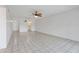 Living room with white tiled floor and view of open door to kitchen at 3717 46Th S Ave # 6, St Petersburg, FL 33711