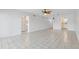 Living room with white tiled floor and view of open door to bathroom at 3717 46Th S Ave # 6, St Petersburg, FL 33711