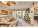 Bright living room with tile flooring, ceiling fan, comfortable sofa, and sliding glass doors to the patio at 3717 46Th S Ave # 6, St Petersburg, FL 33711