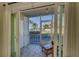 Enclosed patio with tile flooring, screens, and a view of palm trees, offering a tranquil outdoor space at 3717 46Th S Ave # 6, St Petersburg, FL 33711