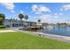 Serene waterfront view with docks and boats along the building, complemented by lush green lawn and blue skies at 3717 46Th S Ave # 6, St Petersburg, FL 33711
