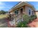 Tan house with wood steps, railings and landscaping at 408 Tighe Ave, Seffner, FL 33584