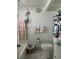 Clean bathroom with flamingo decor and shelving at 4525 Cove Cir # 1002, St Petersburg, FL 33708