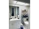 Well-lit bathroom with white vanity and storage at 4525 Cove Cir # 1002, St Petersburg, FL 33708