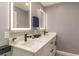 Double vanity bathroom with modern fixtures and sleek, illuminated mirrors at 4925 New England Blvd # 204, New Port Richey, FL 34652