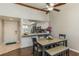 Bright dining area with a table, bench, and view into the updated kitchen at 4925 New England Blvd # 204, New Port Richey, FL 34652