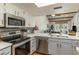 Updated kitchen with stainless steel appliances and breakfast bar at 4925 New England Blvd # 204, New Port Richey, FL 34652