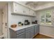 Modern kitchen features gray cabinets, quartz countertops, and stainless steel appliances at 4925 New England Blvd # 204, New Port Richey, FL 34652