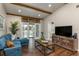 Living room with hardwood floors, sliding glass doors, and a large flat-screen TV at 4925 New England Blvd # 204, New Port Richey, FL 34652