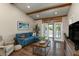 Spacious living room with hardwood floors, sectional sofa, and access to a patio at 4925 New England Blvd # 204, New Port Richey, FL 34652