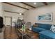 Open concept living area with hardwood floors, sectional sofa, and a view of the kitchen at 4925 New England Blvd # 204, New Port Richey, FL 34652