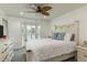 Main bedroom with a king-size bed, ceiling fan, and plenty of natural light at 4925 New England Blvd # 204, New Port Richey, FL 34652