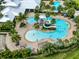 Aerial view of resort-style pool with water slide, multiple pools, and clubhouse at 6230 Mooring Line Cir, Apollo Beach, FL 33572