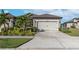 House exterior featuring a two-car garage and well-manicured landscaping at 6230 Mooring Line Cir, Apollo Beach, FL 33572