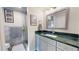 Stylish bathroom featuring a shower, modern vanity with a green counter, and attractive fixtures at 6888 121St N St, Seminole, FL 33772