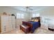 Cozy bedroom with hardwood furniture, tile floor, and sunny windows at 6888 121St N St, Seminole, FL 33772