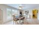 Charming dining area with a table and four chairs, near a sliding glass door at 6888 121St N St, Seminole, FL 33772