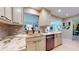 Modern kitchen with granite countertops, stainless steel appliances, and stylish backsplash at 6888 121St N St, Seminole, FL 33772