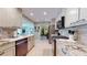 Modern kitchen with stainless steel appliances and granite countertops opens to a dining area at 6888 121St N St, Seminole, FL 33772