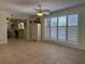 Bright living room features tile flooring, ceiling fan, and large windows with plantation shutters at 6888 121St N St, Seminole, FL 33772