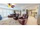 Relaxing living room with leather armchairs, a view of the kitchen, and ample natural light at 6888 121St N St, Seminole, FL 33772