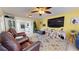 Spacious living room with leather armchairs, large TV, and eclectic decor at 6888 121St N St, Seminole, FL 33772