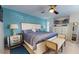 Tranquil main bedroom with blue accent wall, ceiling fan, and coordinated furnishings at 6888 121St N St, Seminole, FL 33772
