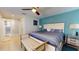 Relaxing main bedroom with ceiling fan, a bench, and an en suite bathroom at 6888 121St N St, Seminole, FL 33772