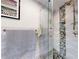 Beautifully tiled shower with a frameless glass door and convenient built-in shelving at 6888 121St N St, Seminole, FL 33772