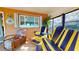 Bright sunroom with fun colors, a variety of chairs, and lots of natural light at 6888 121St N St, Seminole, FL 33772