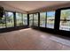 Bright sunroom with tile floor, canal views, and lots of windows for enjoying the Florida sunshine at 6888 121St N St, Seminole, FL 33772