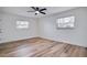 Spacious bedroom with hardwood floors and ceiling fan at 7280 Danbury Way, Clearwater, FL 33764