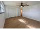 Bright and airy bedroom with wood-look floors, closet space, and modern ceiling fan at 7521 Bougenville Dr, Port Richey, FL 34668