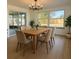 Dining area with table and six chairs with sliding door access to outside at 7521 Bougenville Dr, Port Richey, FL 34668