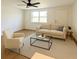 Staged living room with contemporary furniture and large window at 7521 Bougenville Dr, Port Richey, FL 34668