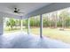 Large covered patio with view of backyard and trees at 8611 Quail Hollow Blvd, Wesley Chapel, FL 33544