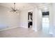 Bright dining room with tile floors and modern chandelier at 8789 Emeraldwood Way, Land O Lakes, FL 34637