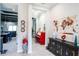 Entryway with decorative wall, red piano, and dark wood cabinet at 8789 Emeraldwood Way, Land O Lakes, FL 34637