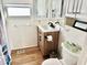 Bathroom with updated vanity and wood-look floor at 9790 66Th N St # 330, Pinellas Park, FL 33782