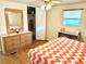 Bedroom with wood dresser and patterned bedding at 9790 66Th N St # 330, Pinellas Park, FL 33782