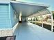 Covered carport with extended patio area leading to the mobile home entrance at 9790 66Th N St # 330, Pinellas Park, FL 33782