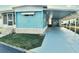 Blue mobile home with carport and landscaped lawn at 9790 66Th N St # 330, Pinellas Park, FL 33782
