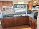 Galley kitchen with wood cabinets and tile backsplash at 9790 66Th N St # 330, Pinellas Park, FL 33782