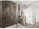 Tiled walk-in shower with glass door and chrome hardware in the Primary bathroom at 1003 Starboard Ct, Oldsmar, FL 34677