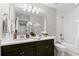 Well-lit bathroom with double vanity and bath-shower combo at 1003 Starboard Ct, Oldsmar, FL 34677