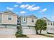 Charming townhouse with a two-car garage, beautiful landscaping, and a well-maintained lawn at 1003 Starboard Ct, Oldsmar, FL 34677