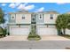 Attractive townhome with a two-car garage, lush landscaping, and a welcoming curb appeal at 1003 Starboard Ct, Oldsmar, FL 34677