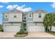 Inviting townhome featuring a two-car garage, manicured landscaping, and a welcoming entrance at 1003 Starboard Ct, Oldsmar, FL 34677
